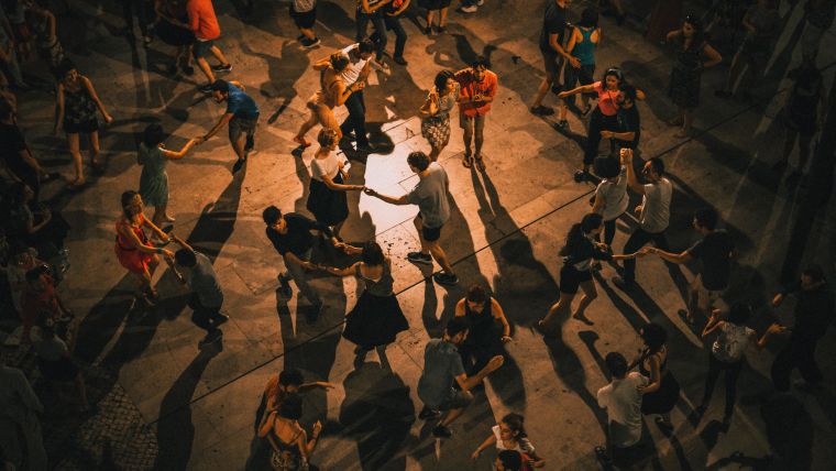 An aerial shot of lots of people dancing outdoors.